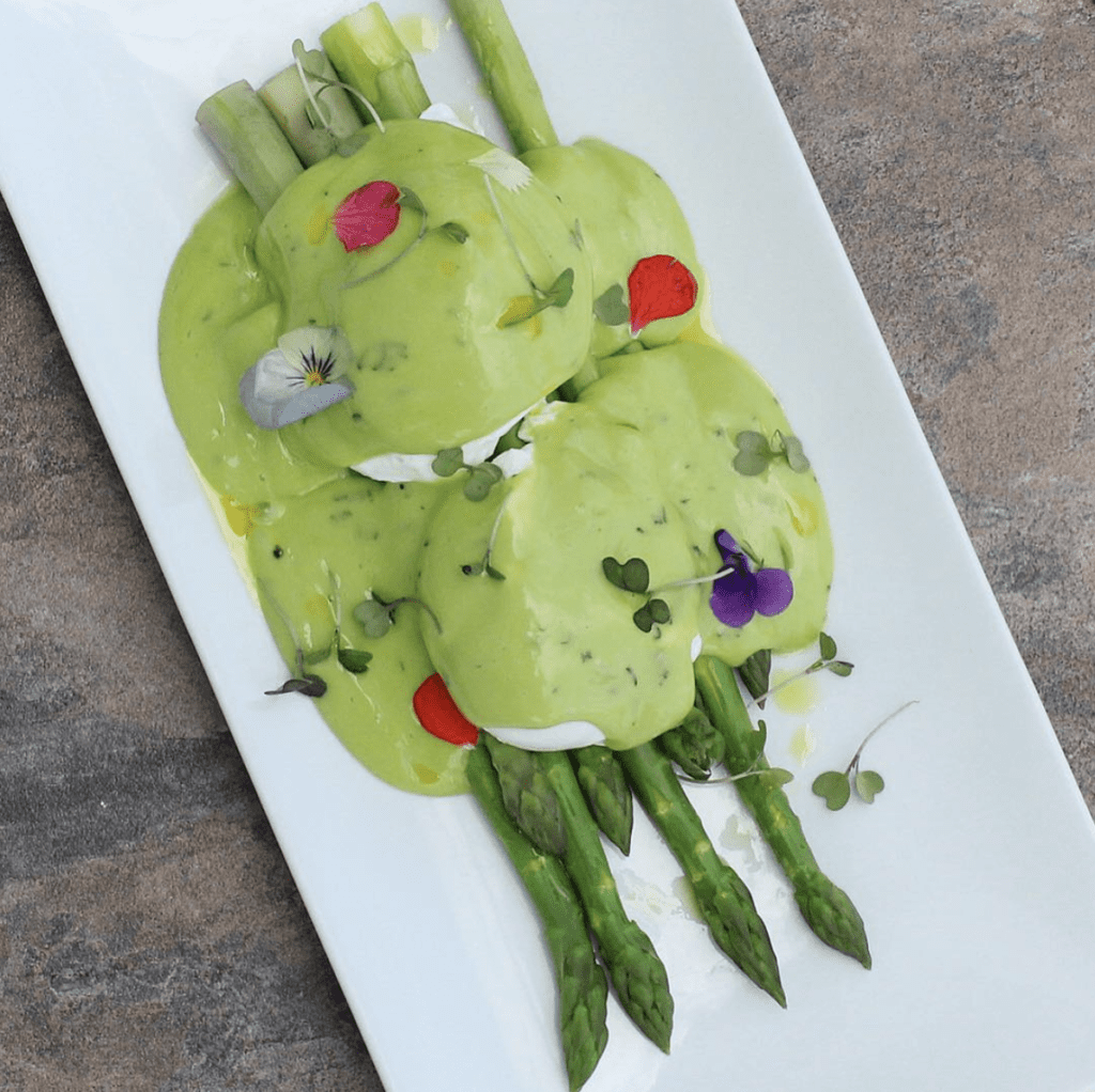 Cabana Panama Brunch Offering Green Benedict on bed of asparagus