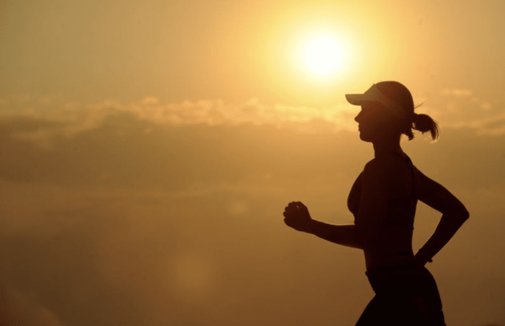 woman-running-with-sunset-behind