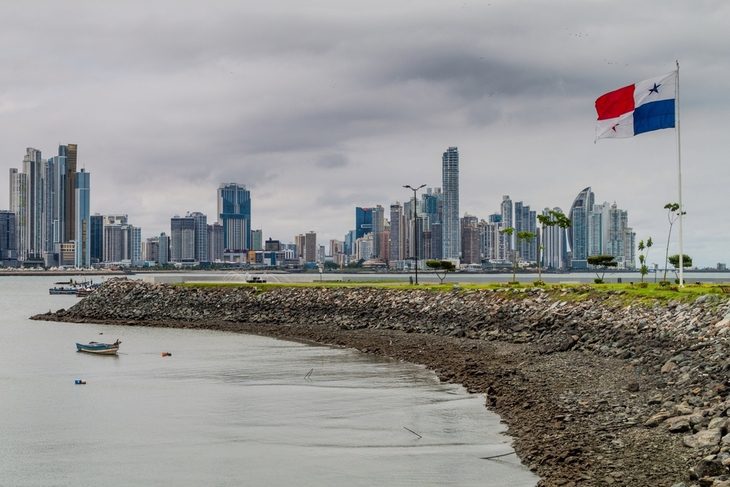 panama flag with view of city in the background